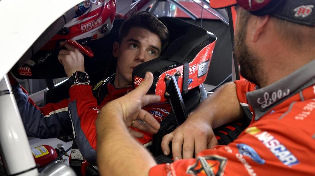 NASCAR Xfinity Series driver Ryan Reed, left, talks with a crew member, right, prior to practice at Charlotte Motor Speedway on Thursday, May 26, 2016.