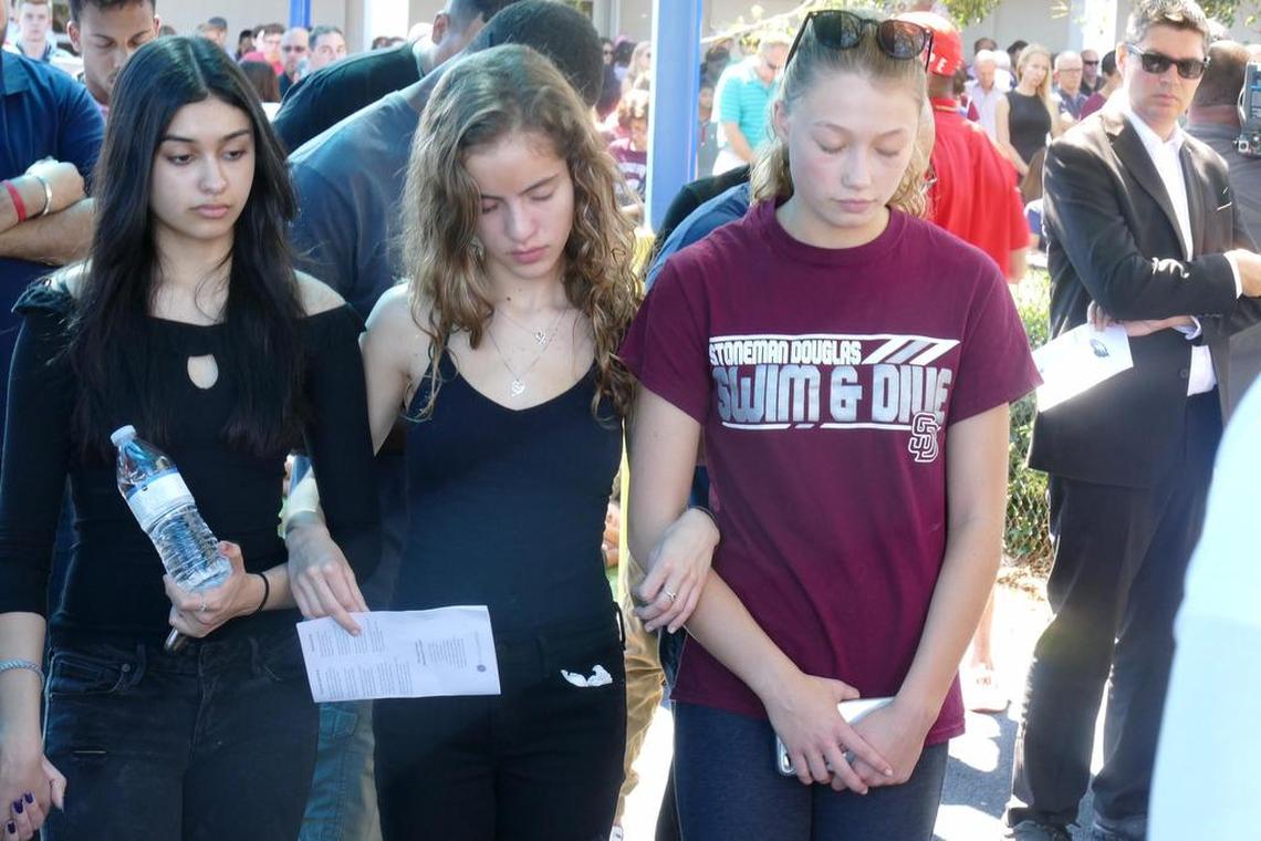 Three young girls participate in a vigil at Parkridge Baptist Church on Thursday, February 15, 2018, for the victims of the shooting at Marjory Stoneman Douglas High School.