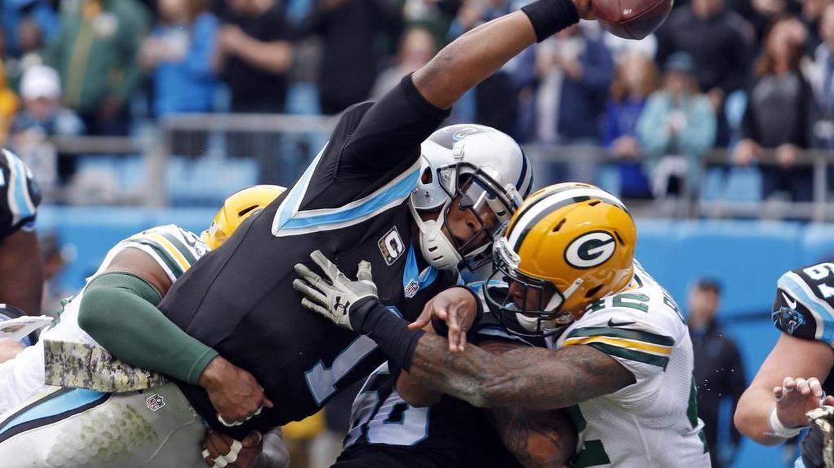 Carolina Panthers’ Cam Newton (1) reaches the ball over the goal line for a touchdown during the team’s Nov. 8, 2015, football game against the Green Bay Packers in Charlotte, N.C. Newton has won The Associated Press NFL Most Valuable Player award in a landslide.