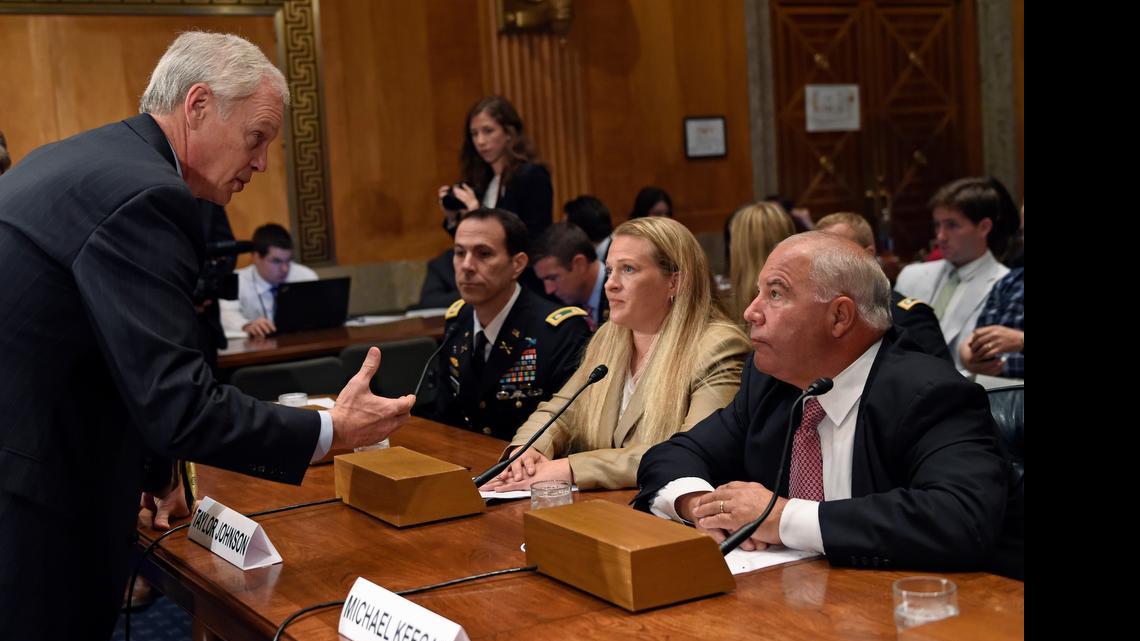 
Senate Homeland Security and Governmental Affairs Committee Chairman Sen. Ron Johnson, R-Wis., left, talks with, from right, former Associate Commissioner for Facilities and Supply Management at the Social Security Administration Michael Keegan; U.S. Immigration and Customs Enforcement Special Agent Taylor Johnson; and Army Lt. Col. Jason Amerine, on Capitol Hill in Washington, Thursday, June 11, 2015, prior to testifying before the committee's hearing: Blowing the Whistle on Retaliation: Accounts of Current and Former Federal Agency Whistleblowers. 
