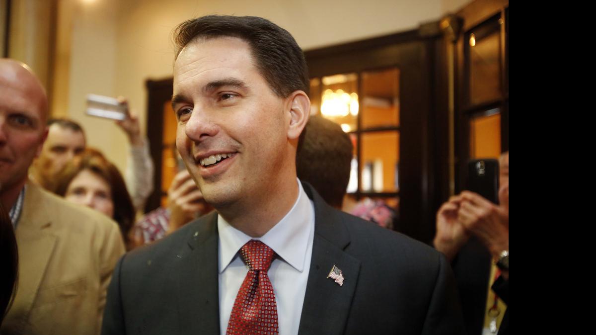 
Wisconsin Gov. Scott Walker smiles as he arrives at the Republican Leadership Summit Saturday, April 18, 2015, in Nashua, N.H. 
