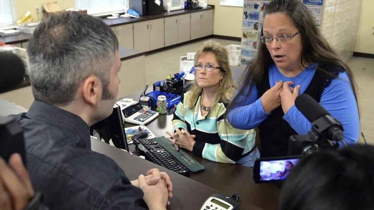 
Rowan County Clerk Kim Davis, right, talks with David Moore following her office’s refusal to issue marriage licenses at the Rowan County Courthouse in Morehead, Ky., Tuesday, Sept. 1, 2015. Although her appeal to the U.S. Supreme Court was denied, Davis still refuses to issue marriage licenses.
