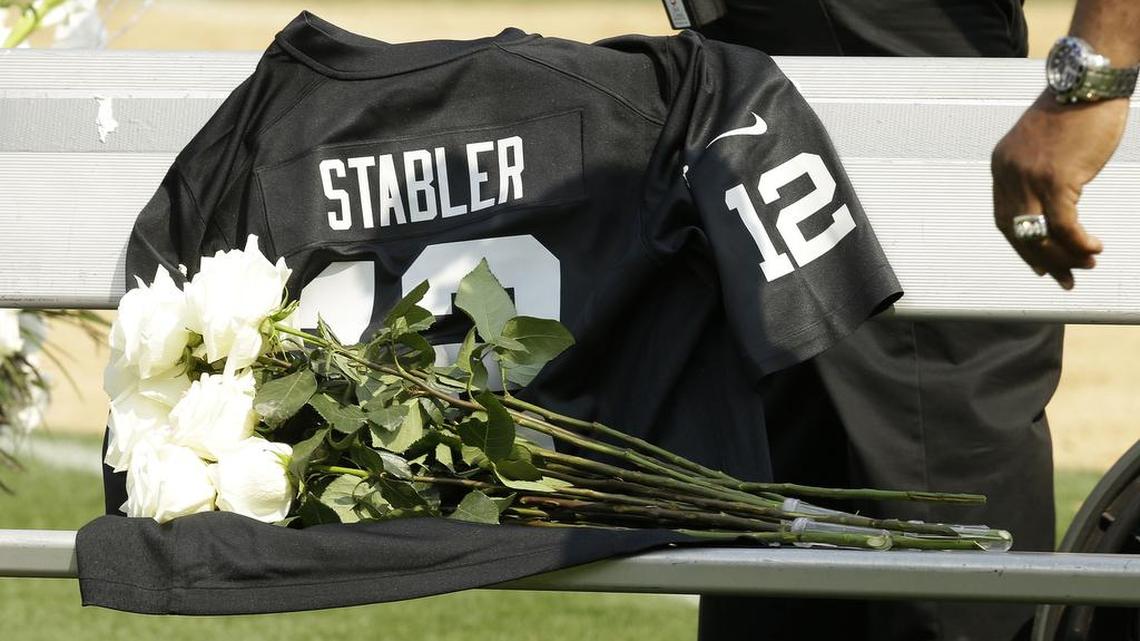 Flowers are placed over the jersey of former Oakland Raiders quarterback Ken Stabler at a ceremony honoring Stabler during halftime of an NFL football game between the Raiders and the Cincinnati Bengals in Oakland, Calif., Sunday, Sept. 13, 2015. Stabler died in July.