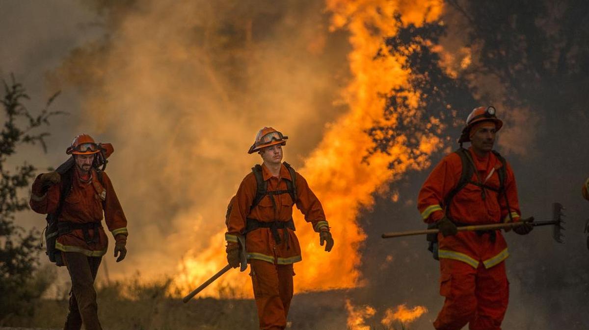 
An inmate crew protects a fire line near backfires south of Highway 20 in Lake County on Sunday. The Rocky fire reached 54,000 acres by Sunday, up from 20,000 acres on Saturday, Cal Fire said.
