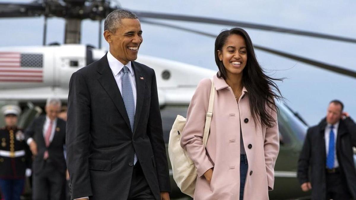 President Barack Obama joked with his daughter Malia Obama as they walk to board Air Force One in an April 2016 file photo.