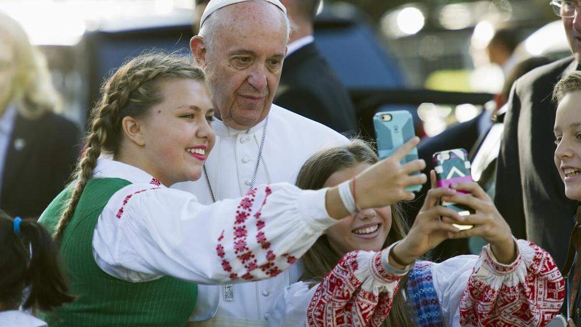 
Children of parents who work at the Lithuanian Embassy take selfies with Pope Francis as he departs the Apostolic Nunciature, the Vatican's diplomatic mission in Washington, Wednesday, Sept. 23, 2015. Pope Francis will visit the White House where President Barack Obama will host a state arrival ceremony.

