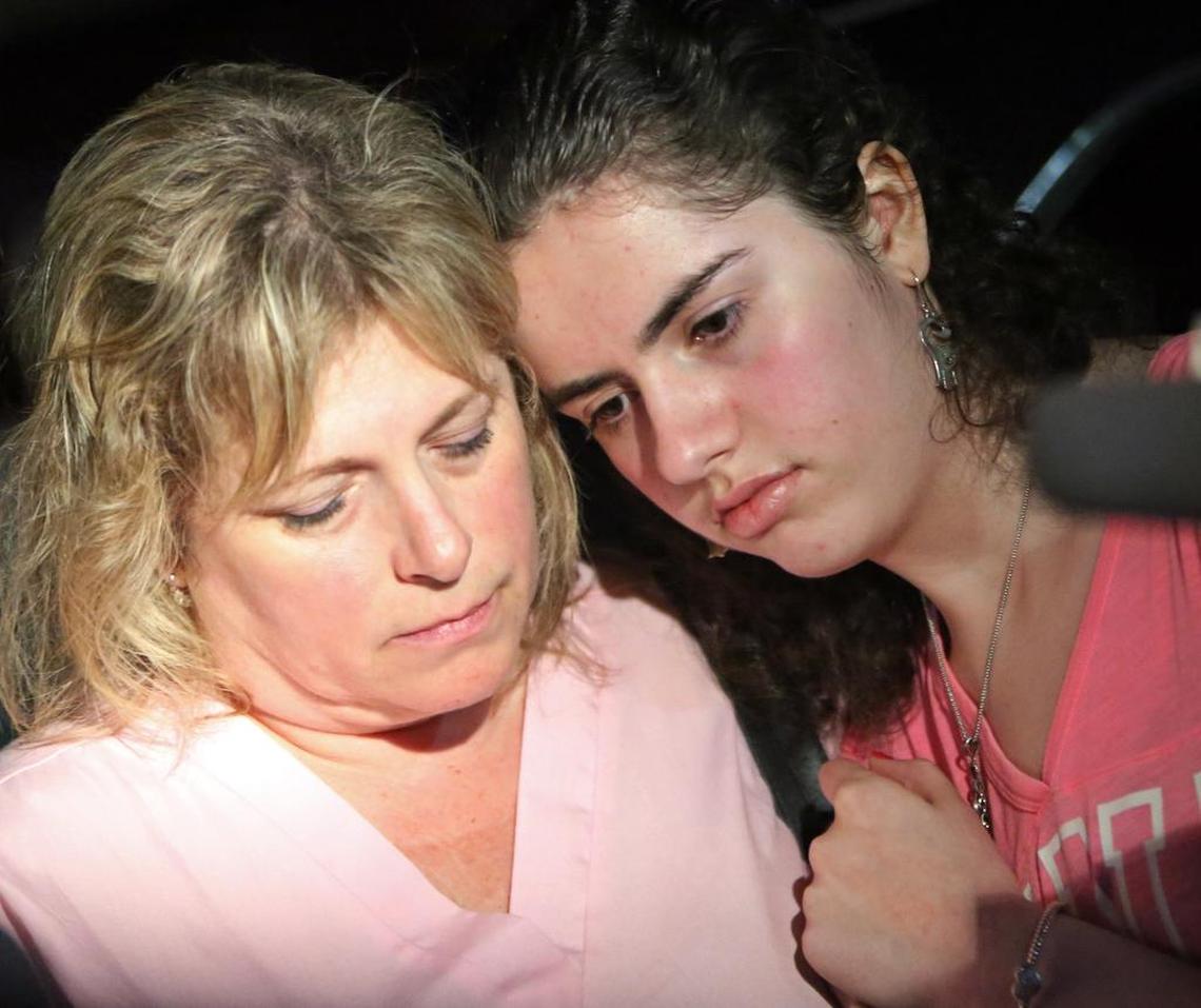 Stacy Crescitelli comforts her daughter, Sarah,15, after they were finally reunited Wednesday night after Sarah spent hours on lock down inside Marjory Stoneman Douglas High School