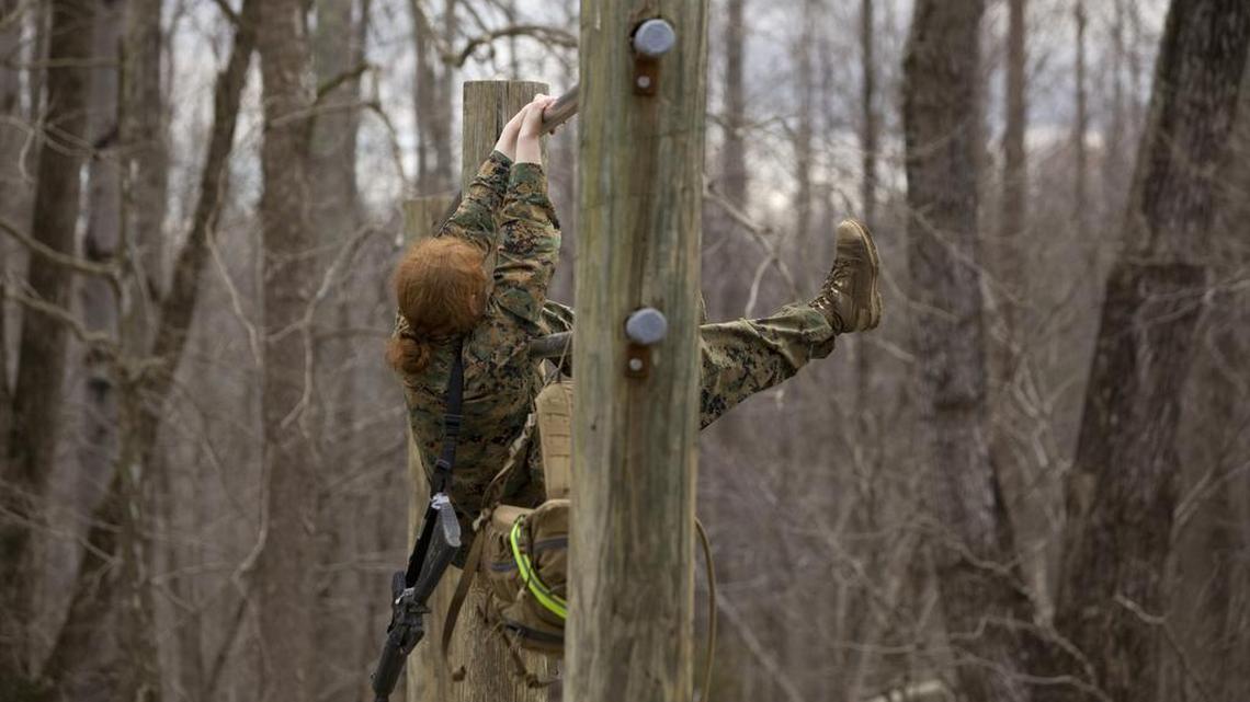 A woman works her way through the obstacles in the Infantry Officer Course at the Marine Corps Base in Quantico, Va., in 2013. A congresswoman from Maine says the U.S. Marine Corps should change tattoo rules she says unintentionally discriminate against female recruits.