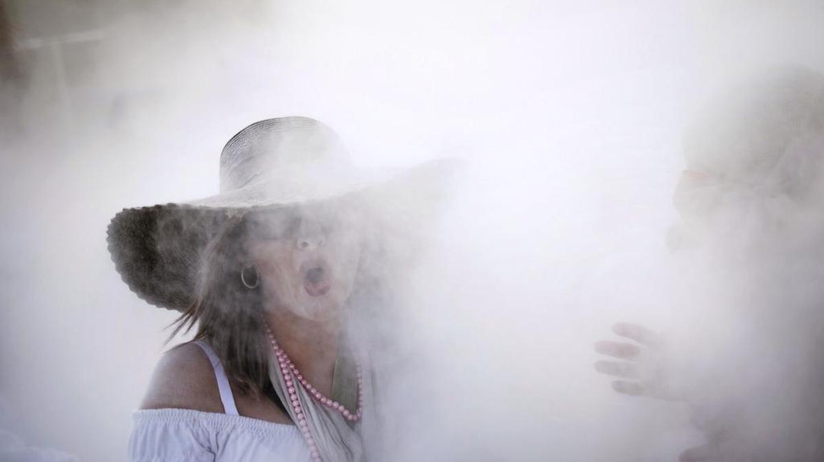 In this photo taken on Monday, Feb. 16, 2015, revellers known as 'Los Indianos', throw talcum powder over each other during carnival in Santa Cruz de la Palma in the Canary Islands, Spain.