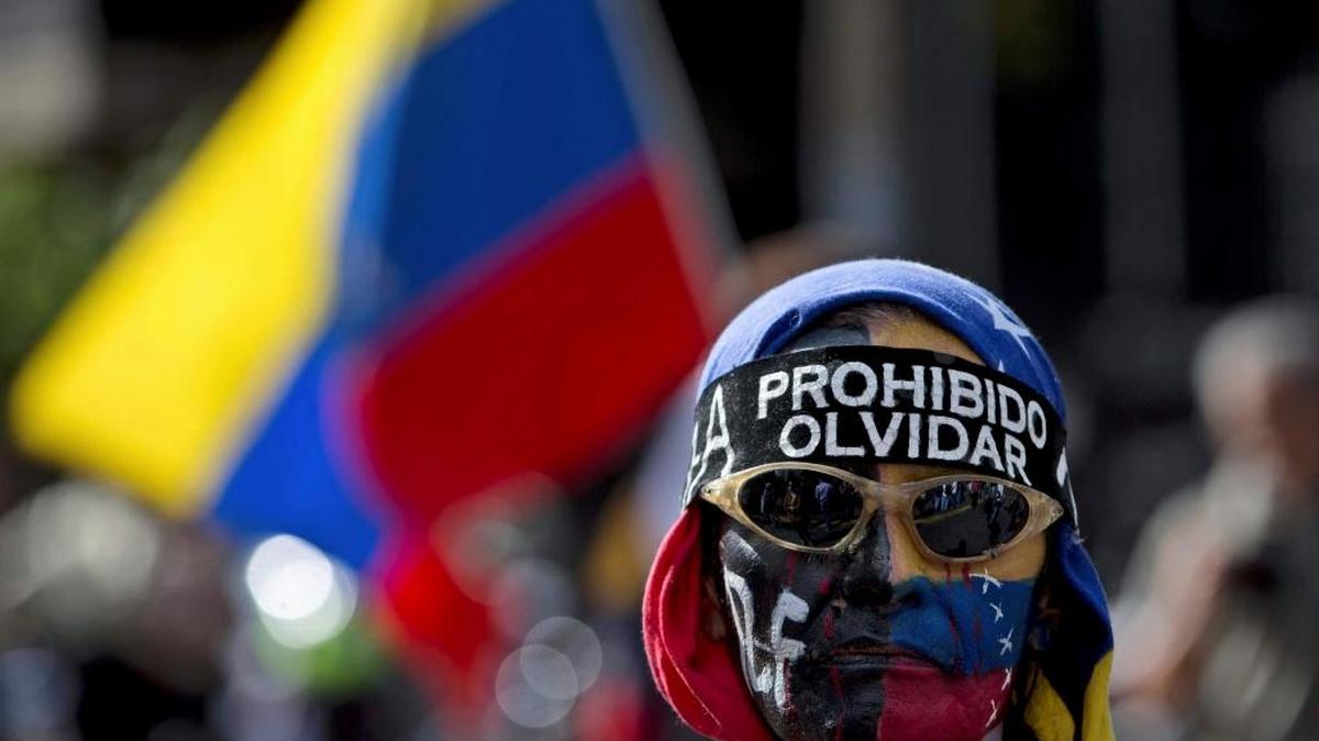 A demonstrator wore a banner that reads in Spanish: “Prohibited to forget” during a protest in Caracas, Venezuela, on Sunday.