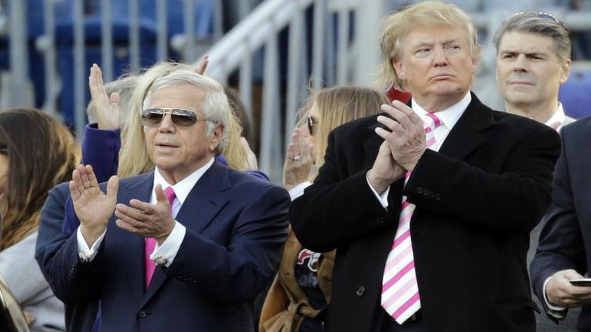 New England Patriots owner Robert Kraft, left, and businessman Donald Trump, right, applaud on the field before an NFL football game between the Patriots and the New York Jets in Foxborough, Mass., Sunday, Oct. 21, 2012.