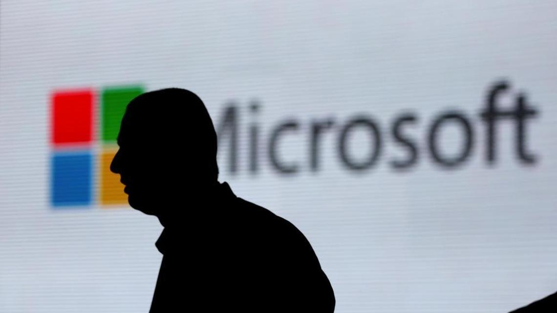 An unidentified man is silhouetted as he walks in front of Microsoft logo at an event in New Delhi, India, on Nov. 17, 2017. U.S. Supreme Court justices will weigh Microsoft’s data privacy posture on Feb. 27.