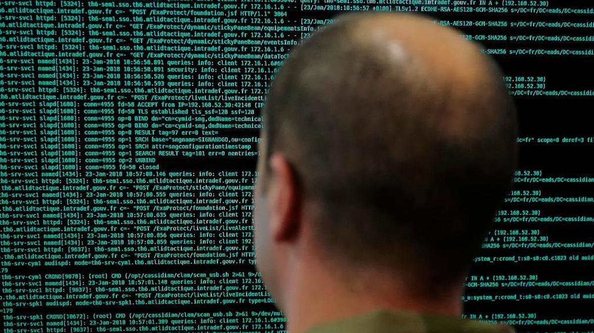 A soldier watches code lines on his computer at the French Defense ministry stand during the International Cybersecurity forum in Lille, northern France, Tuesday Jan. 23, 2018.