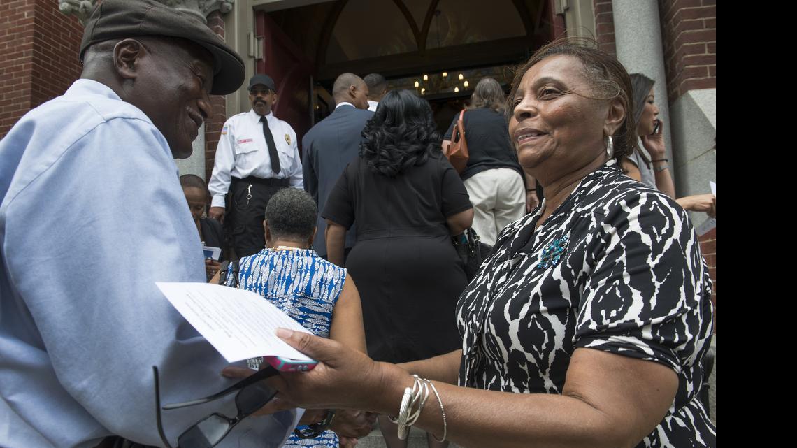 
Linda Jefferson greets members of the public arriving at a prayer vigil at the Metropolitan African Methodist Episcopal Church in Washington, DC on June 19. There has been a noticeable increase in violence at houses of worship. Fatal attacks have grown from a mere handful a decade ago to 74 last year, and religious institutions are responding. 
