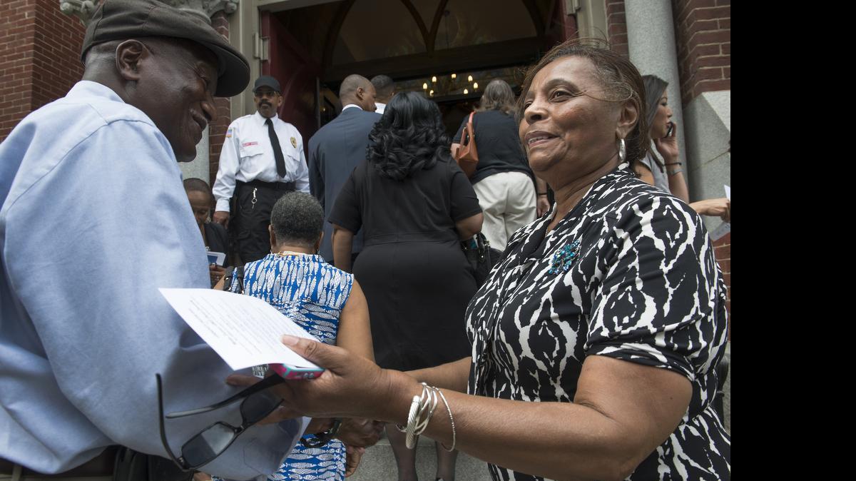 
Linda Jefferson greets members of the public arriving at a prayer vigil at the Metropolitan African Methodist Episcopal Church in Washington, DC on June 19. There has been a noticeable increase in violence at houses of worship. Fatal attacks have grown from a mere handful a decade ago to 74 last year, and religious institutions are responding. 
