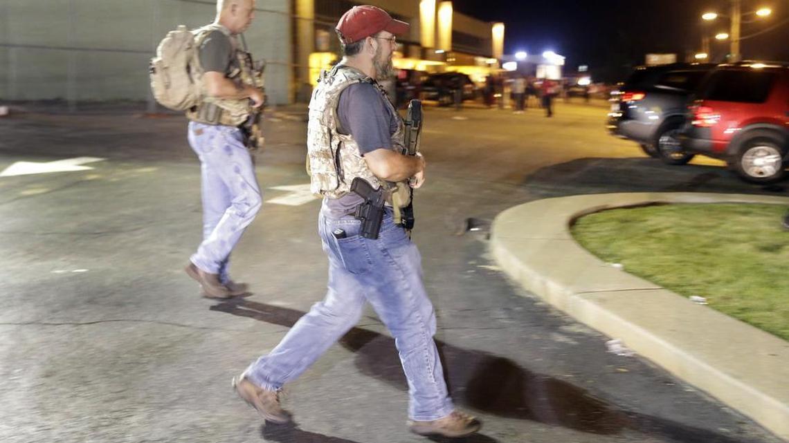 
Heavily armed civilians with a group known as the Oath Keepers arrive in Ferguson, Mo., early Tuesday, Aug. 11, 2015. The far-right anti-government activists, largely consists of past and present members of the military, first responders and police officers. St. Louis County Police Chief Jon Belmar said the overnight presence of the militia group, wearing camouflage bulletproof vests and openly carrying rifles and pistols on West Florissant Avenue, the hub of marches and protests for the past several days, was "both unnecessary and inflammatory." 

