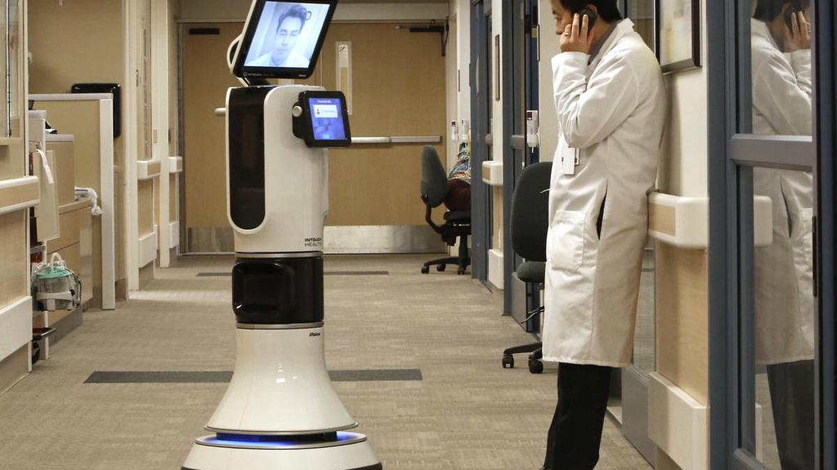 
Dr. Alan Shatzel is displayed on the monitor of the RP-VITA robot as he waits to confer with Dr. Alex Nee at Mercy San Juan Hospital in Carmichael, Calif., on Nov. 6, 2013. The robot, which combines navigation and mobility technology from iRobot and telemedicine technology from InTouch Health, allows doctors to "beam" themselves into hospitals to diagnose patients and offer medical advice during emergencies.
