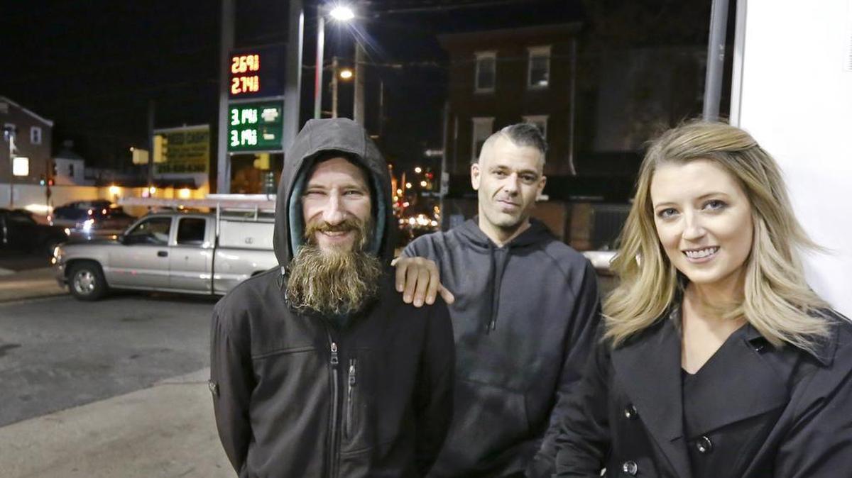 In this Nov. 17, 2017 photo, Johnny Bobbitt Jr., left, Kate McClure, right, and McClure's boyfriend Mark D'Amico pose at a CITGO station in Philadelphia. When McClure ran out of gas, Bobbitt, who was homeless, gave his last $20 to buy gas for her. McClure started a Gofundme.com campaign for Bobbitt that has raised more than $13,000.