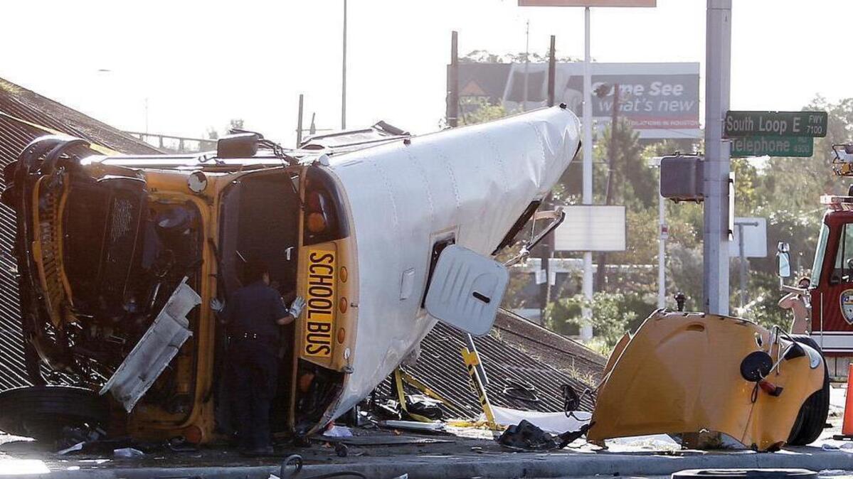 
An emergency worker looks inside a school bus after the bus went off a Houston freeway and rolled in southeast Houston on Tuesday, Sept. 15, 2015. 

