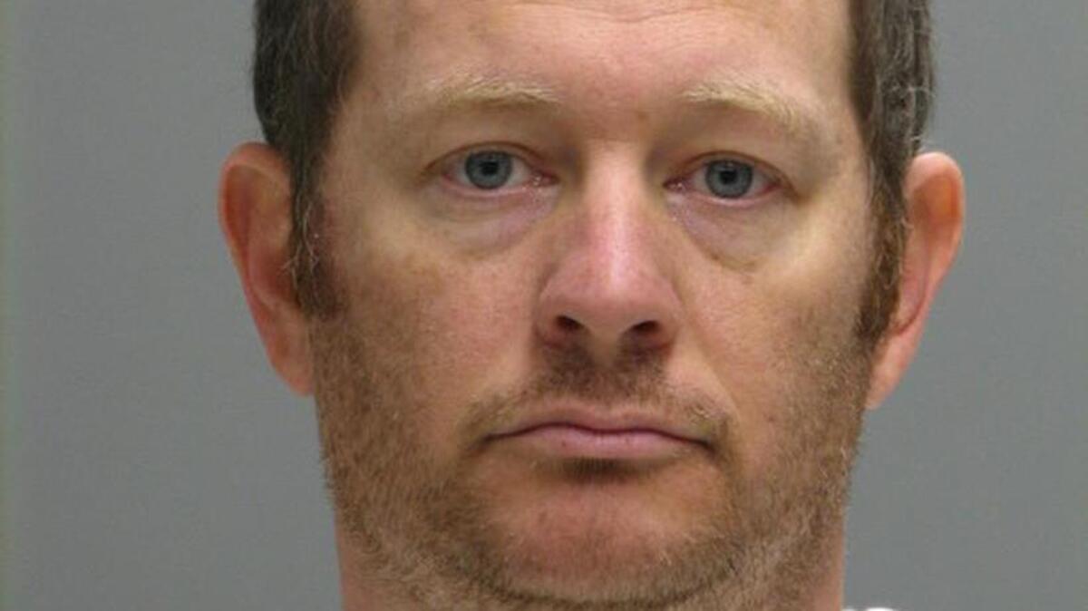 This booking photo provided by the Delaware Department of Justice shows Lee Robert Moore. Federal authorities say Moore, a Secret Service agent from Maryland, sent obscene images and texts to someone he thought was a young Delaware girl, sometimes while on duty at the White House.