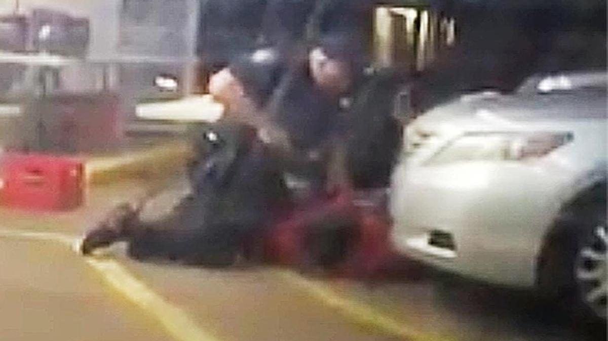 In this Tuesday, July 5, 2016 photo made from video, Alton Sterling is held by two Baton Rouge police officers, with one holding a hand gun, outside a convenience store in Baton Rouge, La. Moments later, one of the officers shot and killed Sterling, a black man who had been selling CDs outside the store, while he was on the ground.