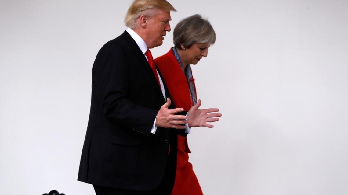 President Donald Trump and British Prime Minister Theresa May walk along the colonnades of the White House, Friday, Jan. 27, 2017.
