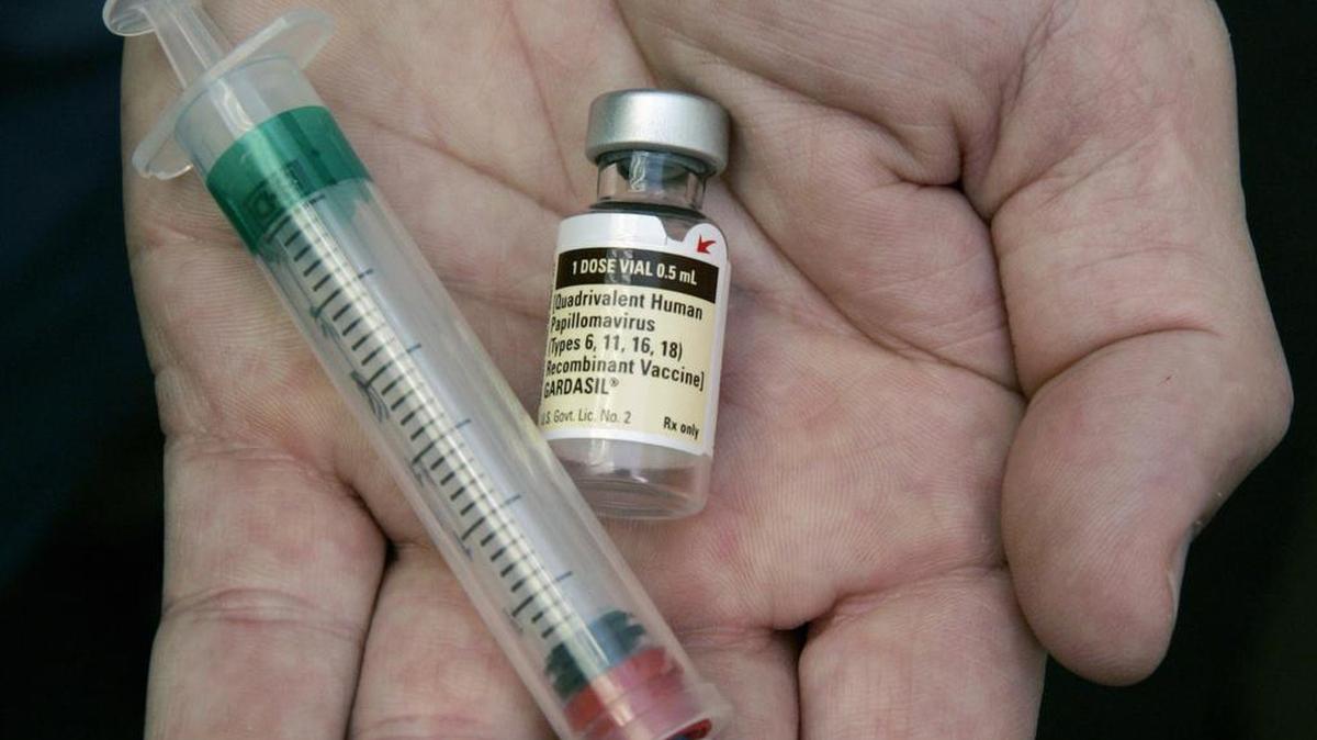 A doctor holds a vial of the human papillomavirus (HPV) vaccine Gardasil. A national estimate suggests that nearly half of U.S. men have mostly silent infections caused by the sexually-transmitted human papilloma virus, and that 1 in 4 has strains linked with several cancers.