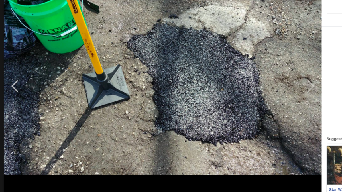 One of the potholes Open Source Roads has patched.