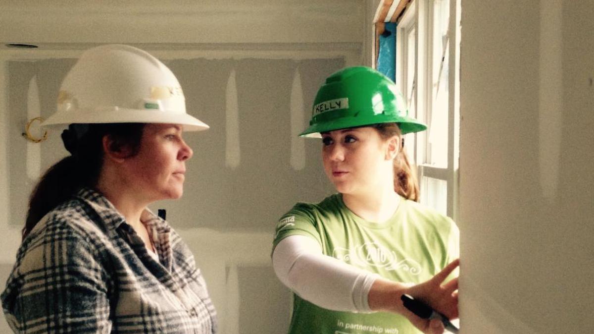 Kelly Renaud, right, construction and program manager for Habitat for Humanity of Northern Virginia, instructs volunteer Kerry Fowler.