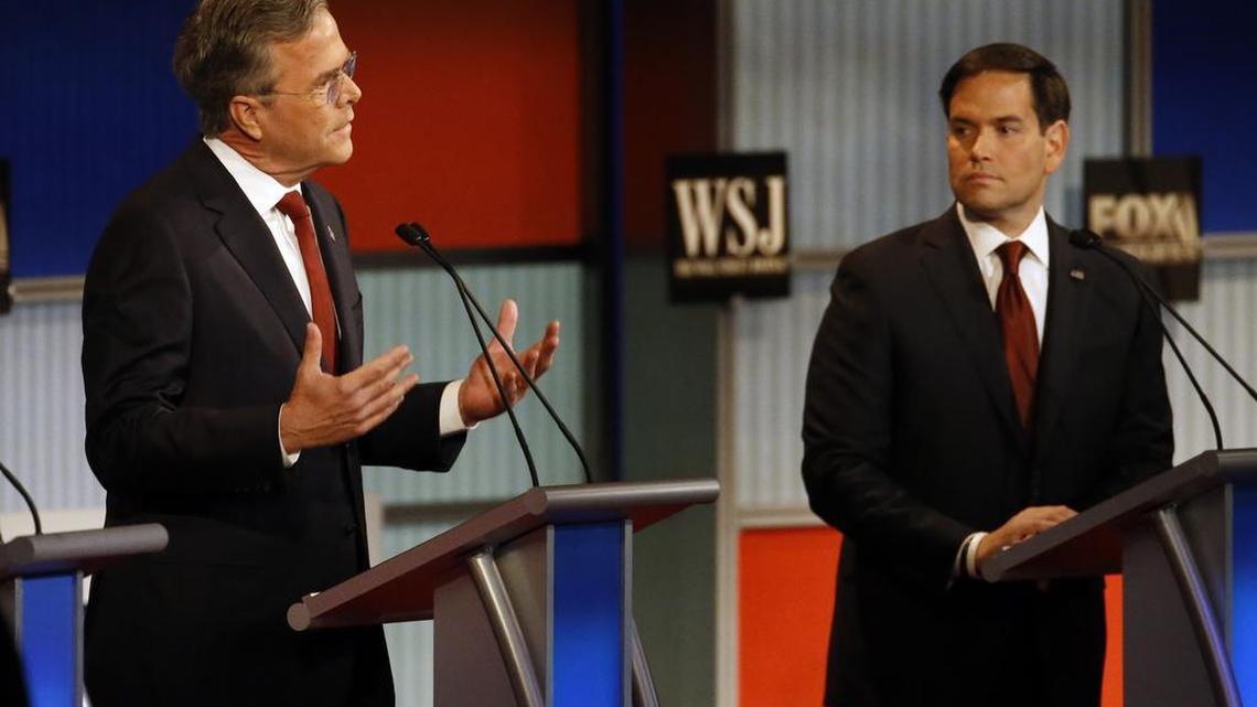 Jeb Bush speaks as Marco Rubio listens during Republican presidential debate at Milwaukee in November.