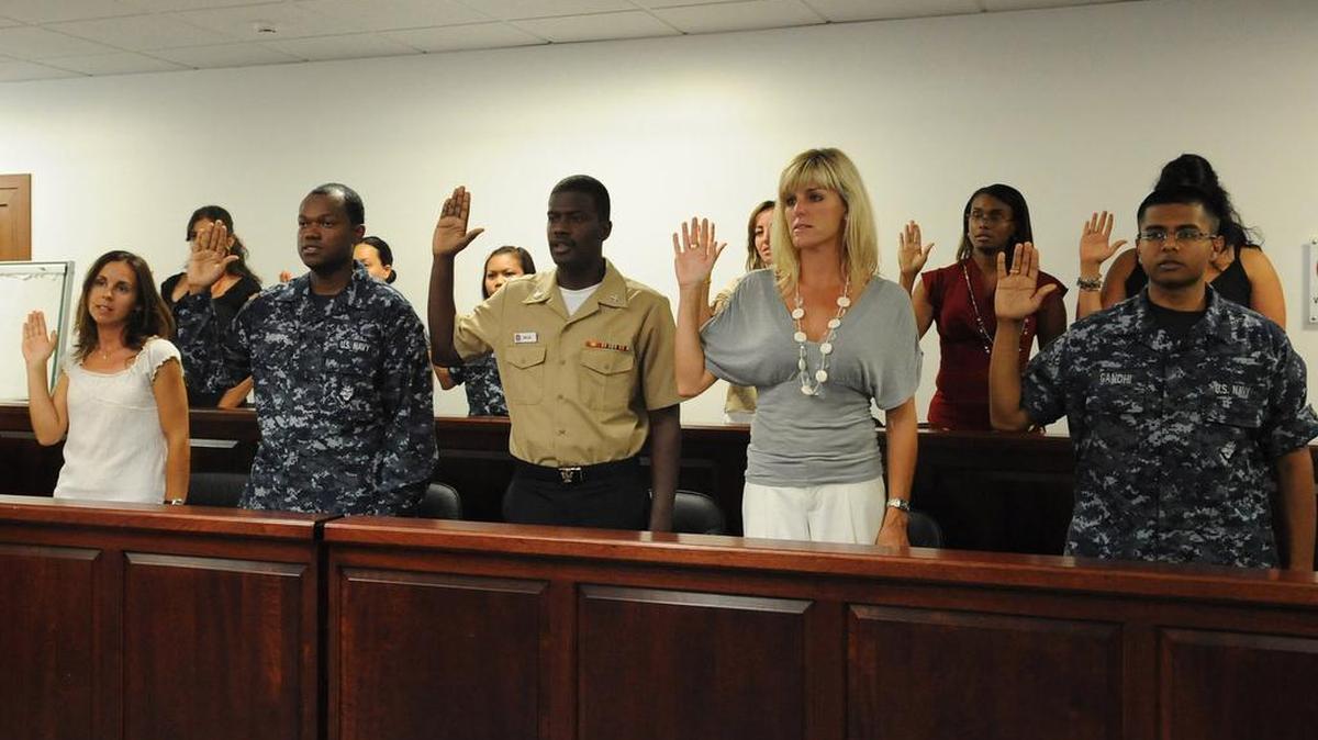 Candidates for U.S. citizenship recite the oath of citizenship during a naturalization ceremony at Naval Air Station Sigonella.