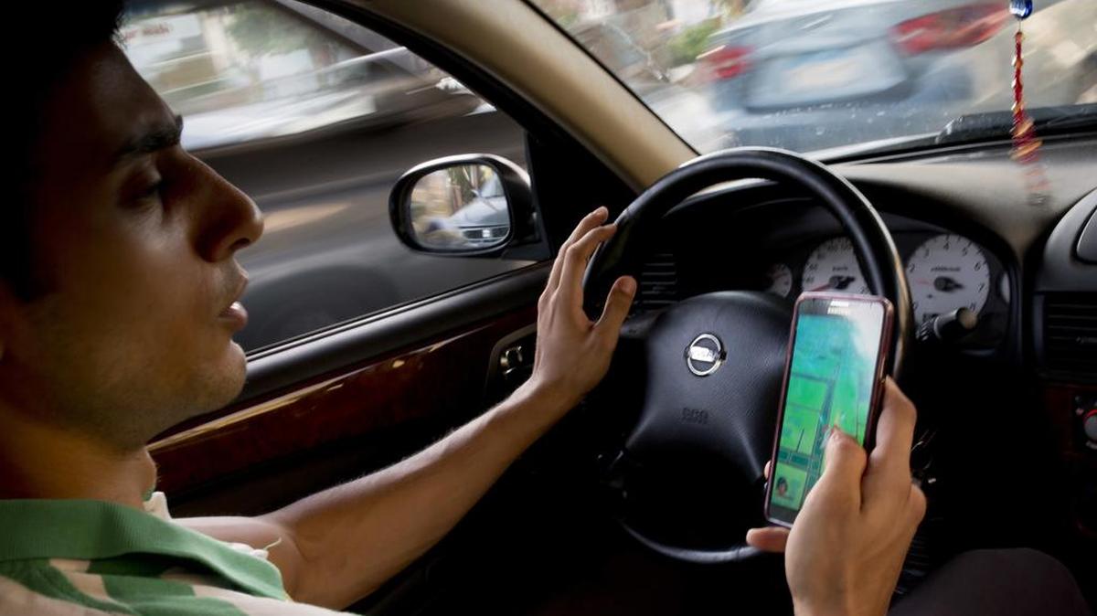 Egyptian dentist Mark Shehata, 24, holds his smartphone as he uses the “Pokémon Go,” mobile phone application while driving on a street in Cairo. A new driving simulator developed by the University of Massachusetts at Amherst and the Arbella Insurance Foundation has been shown to reduce accidents by 19 percent among the people who’ve participated in the program.