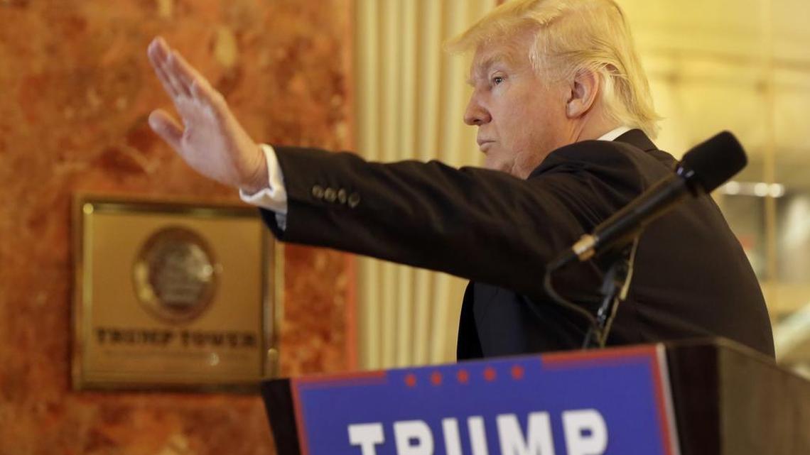 Republican presidential candidate Donald Trump waves as he leaves a press conference in New York on Tuesday. (AP Photo/Richard Drew)