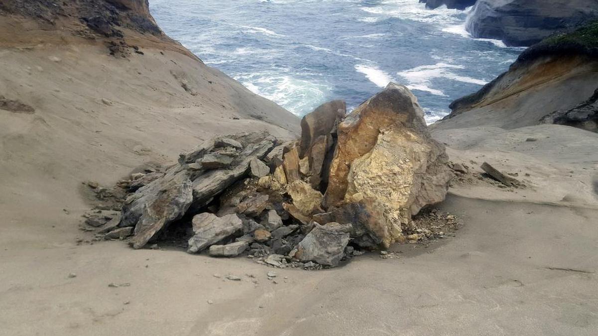 This undated photo provided by the Oregon Parks and Recreation Department shows a natural rock formation that was found in pieces last week at Cape Kiwanda State Natural Area, which is a state park in Pacific City, Ore. The sandstone pedestal was roughly 7 feet to 10 feet across and located in a fenced off section of the park. Oregon State Parks officials originally said they did not think the break at the site frequented by tourists was caused by humans but cellphone video captured a group of people knocking over the popular sandstone rock formation known as the “Duckbill” on the Oregon beach.