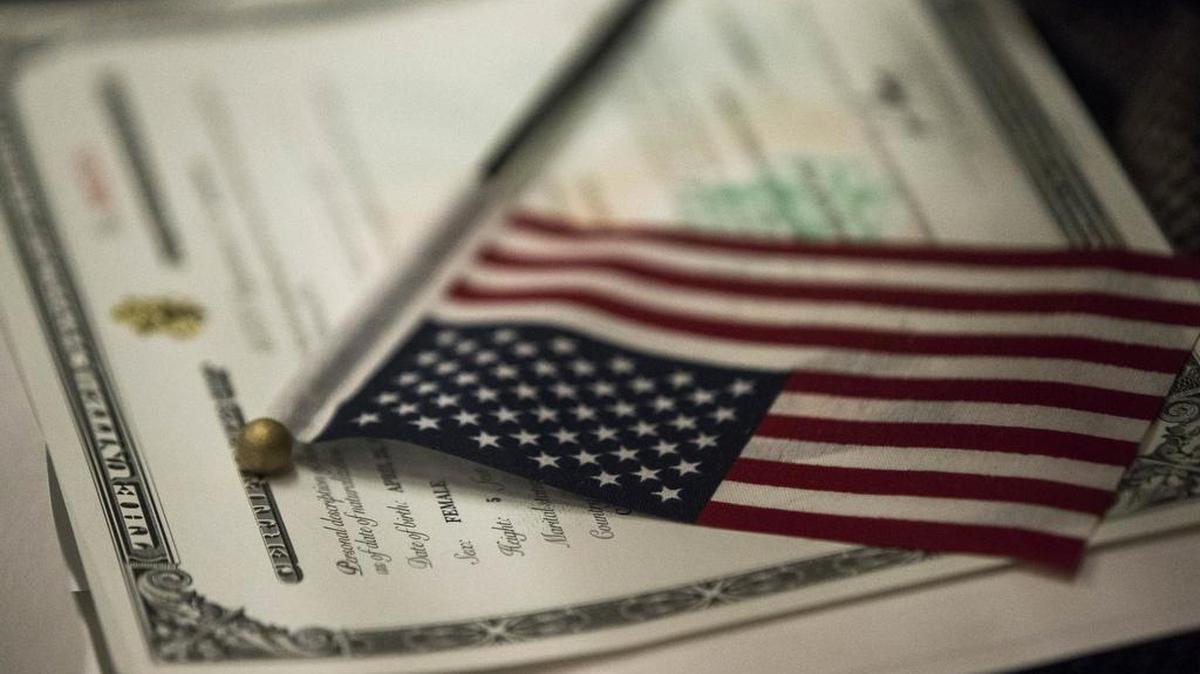 An American flag rests on a Certificate of Citizenship during a naturalization ceremony in New York. On Thursday, a federal judge told soon-to-be U.S. citizens to “go to another country” if they could not accept Donald Trump as president.