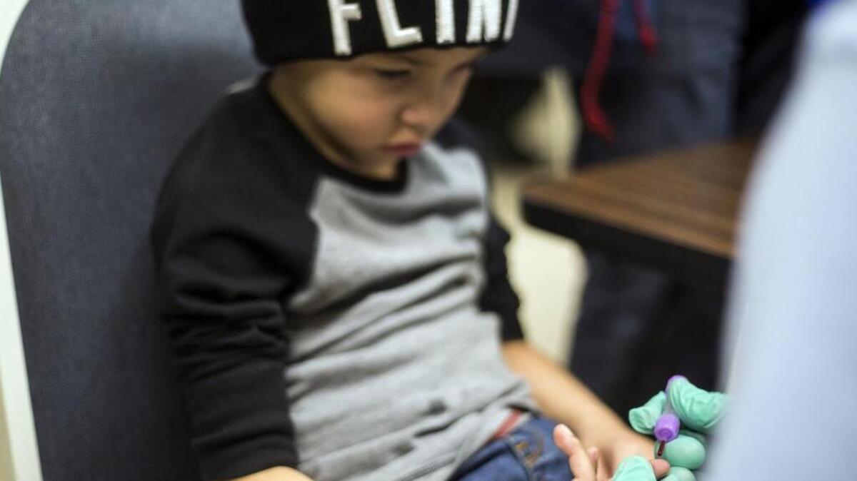 Grayling Stefek, 5, has his blood drawn during a free lead-testing event and family fun night for children on Tuesday, Jan. 26, 2016, at Eisenhower Elementary school in Flint, Mich. The Flint water crisis has other government leaders thinking about the issue of lead poisoning.
