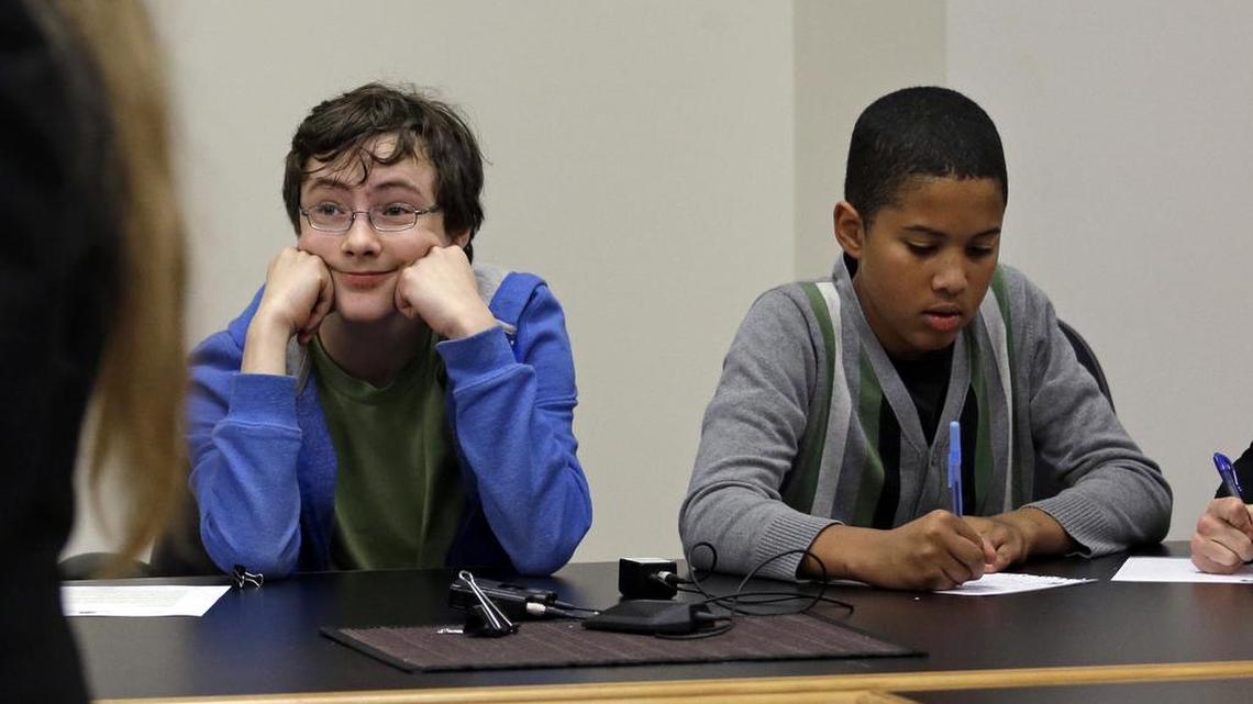 Petitioners Gabe Mandell, 14, left, and Adonis Williams, 12, look on as an attorney speaks at a court hearing Tuesday, Nov. 22, 2016, in Seattle.