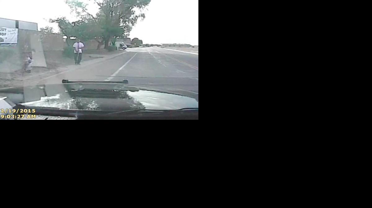 
In this Feb. 19, 2015, frame from a dash cam video provided by the Marana Police Department, Mario Valencia faces a police vehicle in Marana, Ariz. Dramatic dash cam video shows a police officer using his cruiser to ram the armed suspect, Valencia, sending him flying in the air. Valencia survived the crash, and prosecutors cleared the officer of any wrongdoing. 
