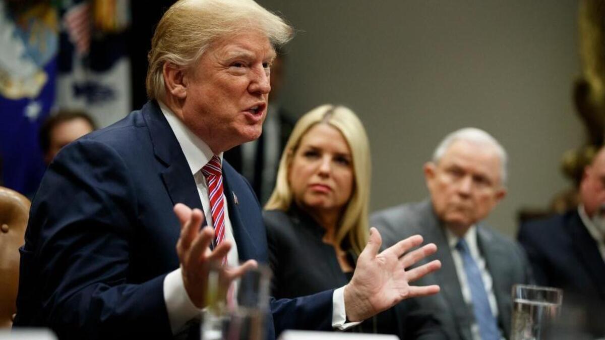 Florida Attorney General Pam Bondi, center, and Attorney General Jeff Sessions, right, look on as President Donald Trump speaks during a meeting with state and local officials to discuss school safety, in the Roosevelt Room of the White House, Thursday, Feb. 22, 2018, in Washington.