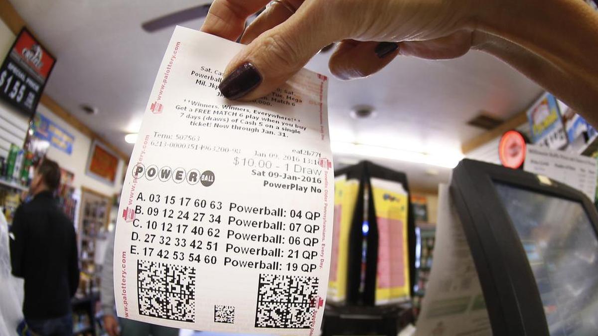 In this photo made with a fisheye lens a clerk hands a patron his $10 worth of chances for the upcoming Powerball drawing on Saturday, Jan. 9, 2016, in Cranberry Township, Pa.