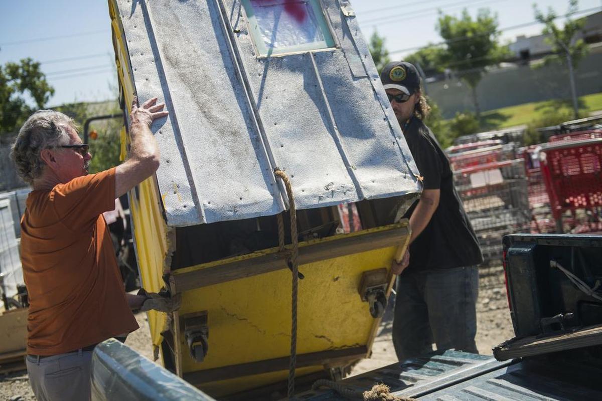 Thomas Mullen and his father, Jim, pull Thomas' "pod" home into the back of his father's truck after picking it up from Caltrans on Thursday July 20, 2017, in Sacramento, Calif. Mullen's pod was taken by Caltrans on July 12 and was damaged in the process.