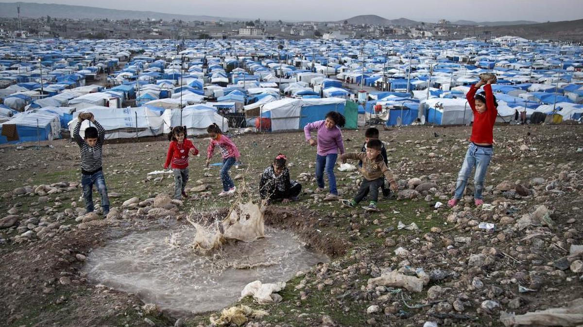In this Saturday, Nov. 28, 2015 photo, Syrian refugee children play at a temporary refugee camp in Irbil, northern Iraq. Some 240,000 refugees who fled the fighting in Syria now live in Iraq. Their children are neither citizens of Syria, their families’ country of origin, or of Iraq, the country where they now live.
