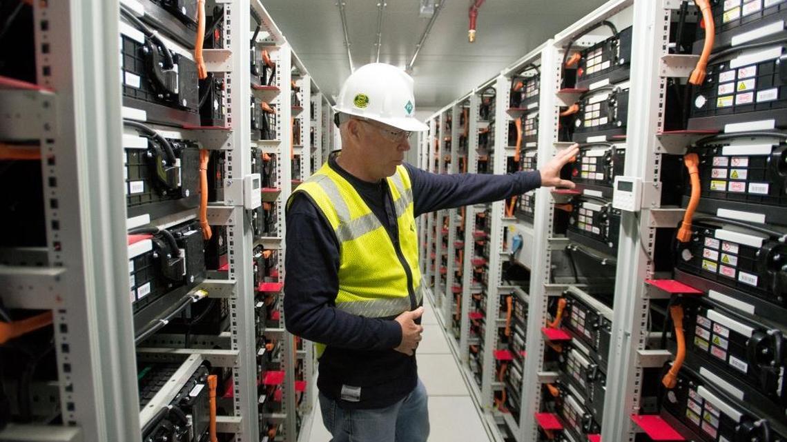 Paul Jusak, Puget Sound Energy commissioning engineer for the Glacier Battery Project, talks about the inner workings of one of four new large battery banks at the project site in Glacier, Wash., on April 13, 2016.