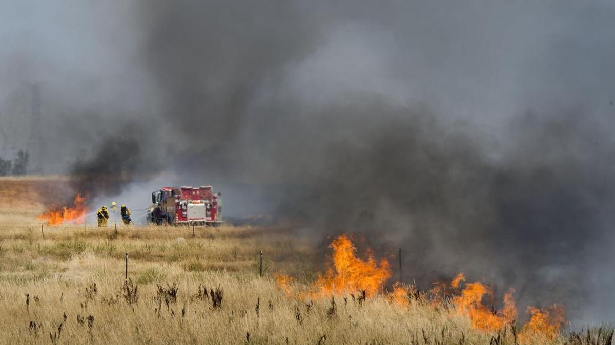 
The Sacramento Metropolitan Fire District responds to a 430-acre grass fire in the Elverta area north of Sacramento, Calif., on Monday.
