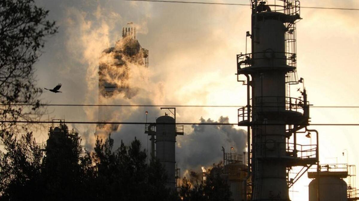 An Exxon Mobil refinery is silhouetted against the sky at dusk in Torrance, California, U.S., on Tuesday, September 18, 2007. Several cities and counties in California have filed lawsuits against Exxon and other oil companies, alleging they conspired to cast doubt on climate change science and delay restrictions on greenhouse gases.