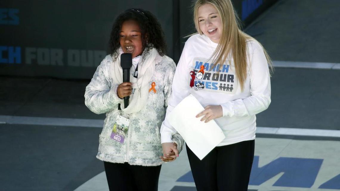Yolanda Renee King, granddaughter of Martin Luther King Jr., speaks as Jaclyn Corin, a student at Marjory Stoneman Douglas High School in Parkland, Fla., and one of the organizers of the rally, holds hands with her during the “March for Our Lives” rally in support of gun control Saturday in Washington.