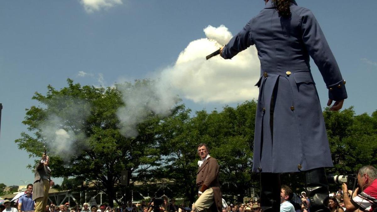 Antonio Burr (in the blue coat) a descendent of Aaron Burr’s cousin fires his pistol towards Douglas Hamilton a fifth great-grandson of Alexander Hamilton during the 200th anniversary historic reenactment of the Hamilton-Burr Duel in Weehawken, N.J., on July 11, 2004.