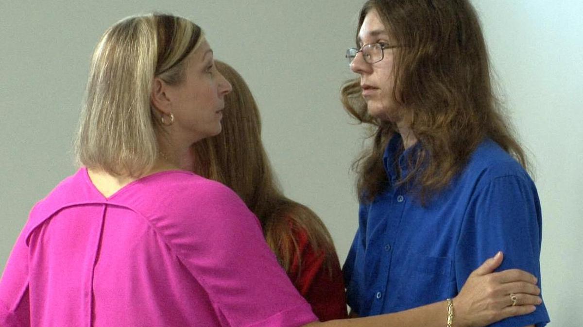 Christine Marshall speaks with her son, Parker Drake, after Nicholas Formica and Christopher Tilton were found guilty in Manasquan, NJ, municipal court Tuesday. The two men have been convicted of endangering the welfare of an incompetent person by coaxing Drake, who is autistic, to jump into a freezing ocean for $20 and cigarettes in a prank that was filmed and posted online.