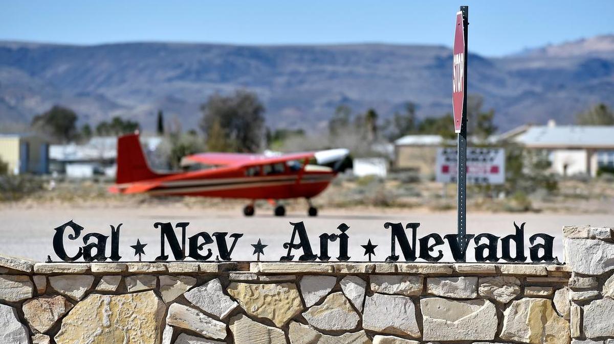 A small single-engine plane is parked just outside the Cal-Nev-Ari Casino in Cal-Nev-Ari, Nev. Nancy Kidwell is offering the entirety of her town for just $8 million.