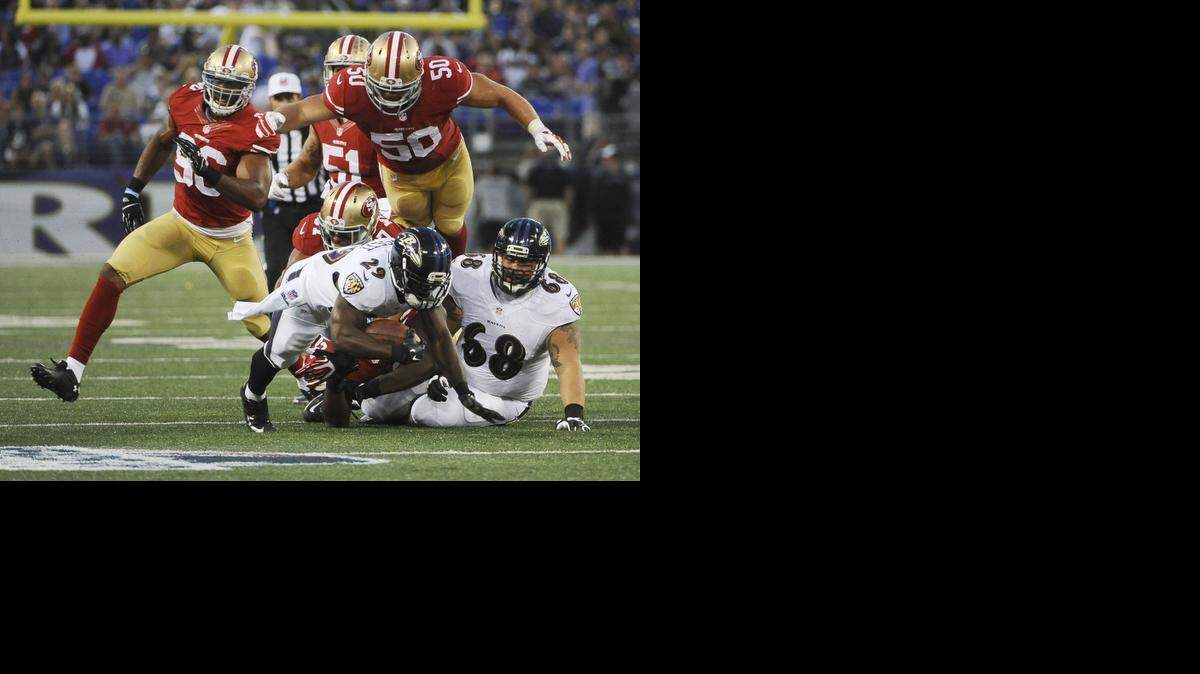 
Baltimore Ravens running back Justin Forsett is taken down by the San Francisco 49ers’ Chris Borland in the first quarter during preseason action at M &amp; T Bank Stadium in Baltimore on Thursday, Aug. 7, 2014. The Ravens won, 23-3. 
